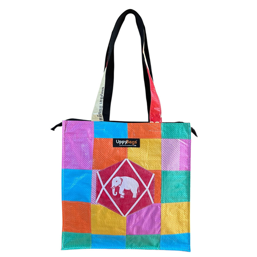Colorful patchwork tote bag with a brand logo on a white background