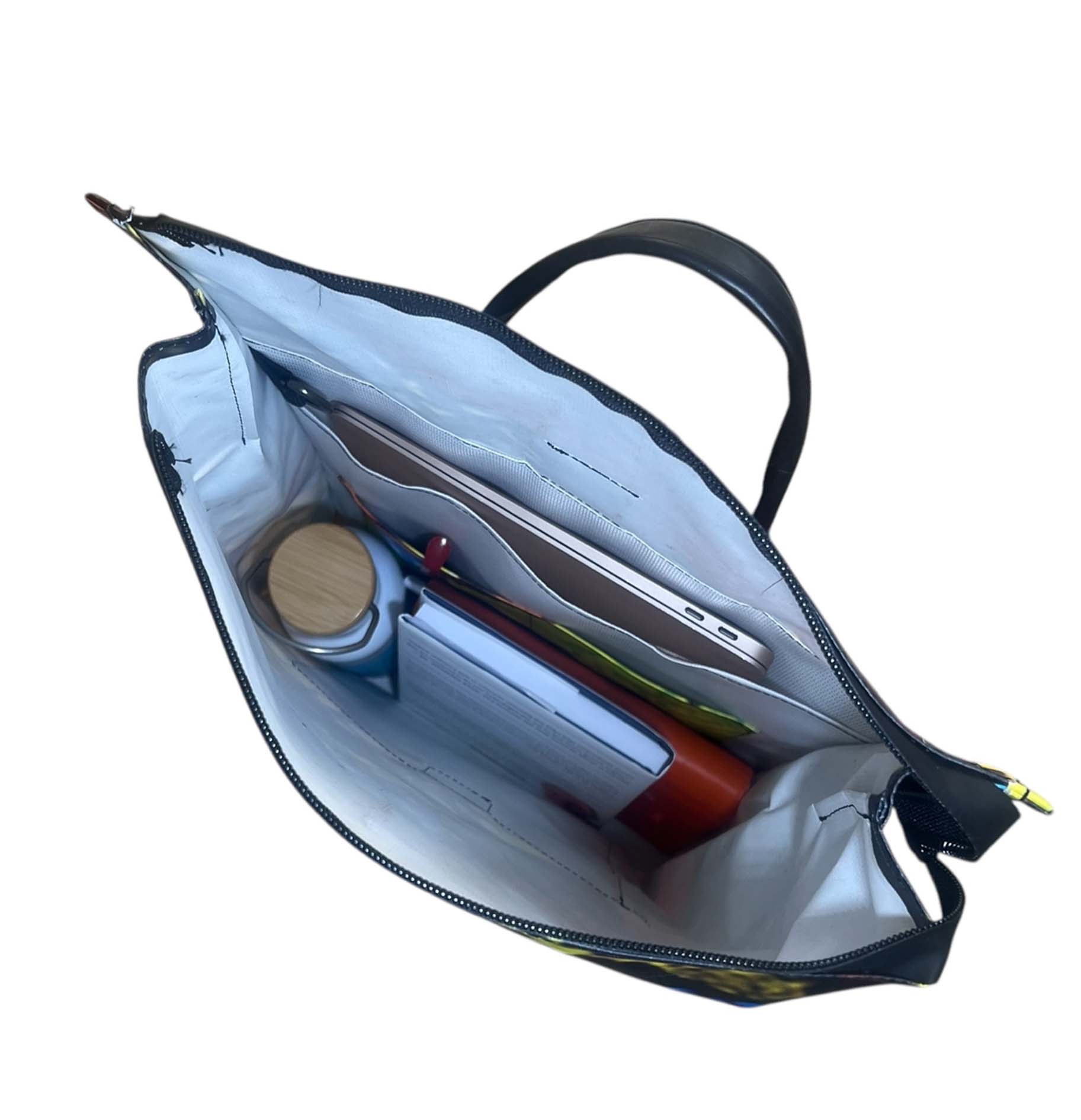 Open backpack, few pockets inside, inside of recycled material backpack.