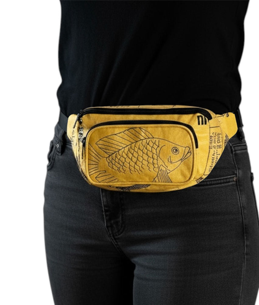 Yellow waist bag with fish design worn by a person on a white background