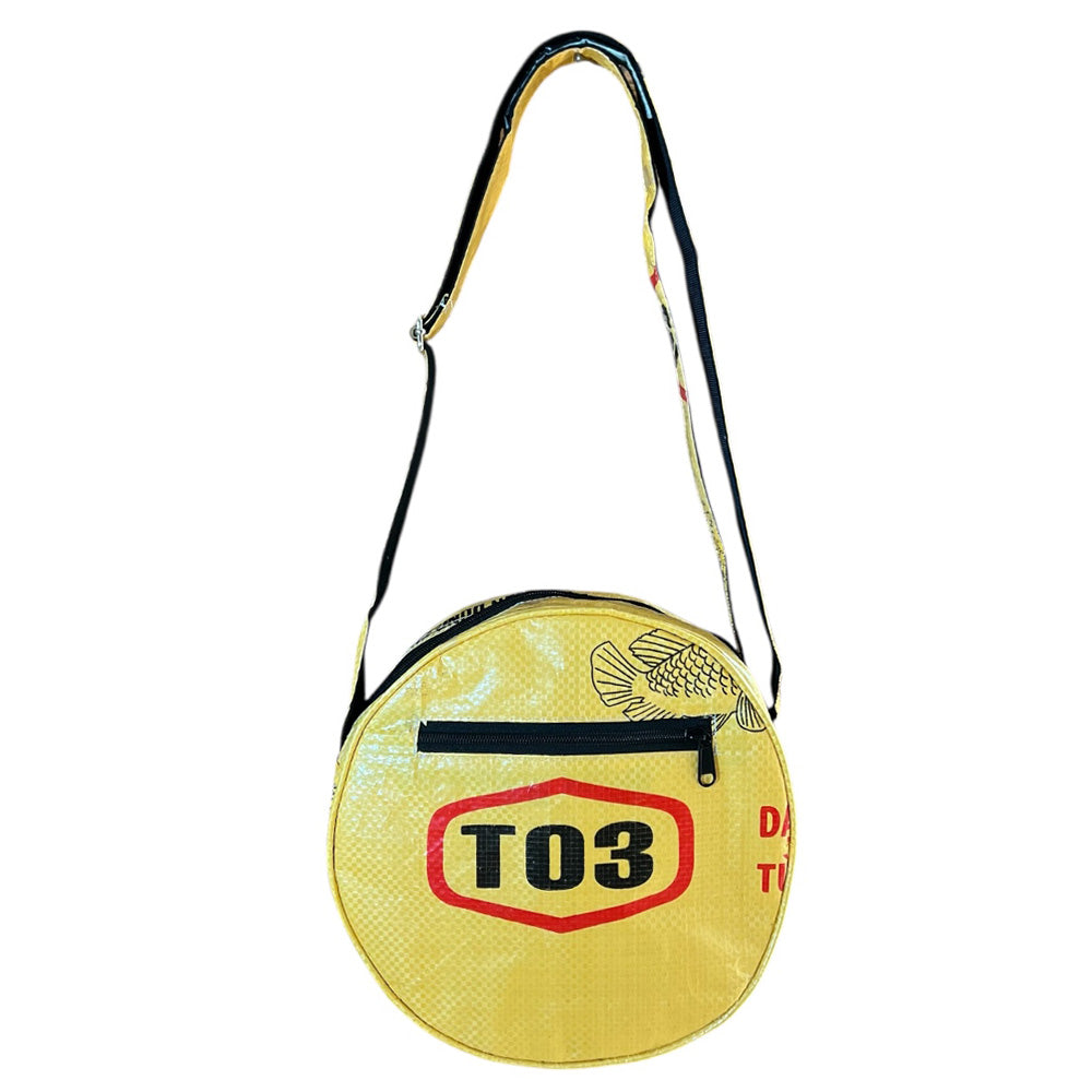 Round yellow bag with black strap and red 'TO3' logo on a white background